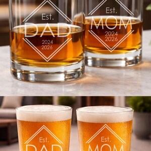 May include: Custom engraved glassware for Mom and Dad, featuring the words "DAD" and "MOM" with the years 2024 and 2026. The image shows stemless wine glasses, whiskey glasses, pint glasses, and beer mugs.