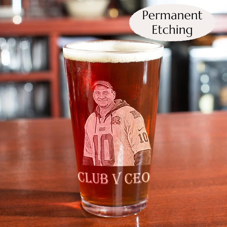 This picture shows a unique personalized glassware engraved custom photo mug sports gift customized drinkware family beer pint present friend glass cup with text.