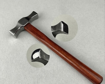 May include: A metal hammer featuring a polished silver-toned head with two distinct striking faces and a smooth, straight wooden handle with a rich brown grain. Two circular insets provide detailed close-up views of the hammer head ends.