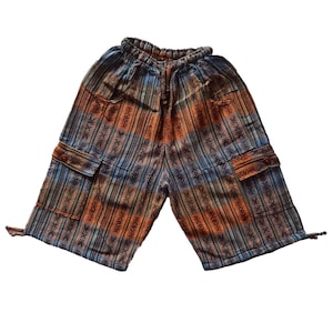 May include: Multi-colored cargo shorts with a striped pattern in shades of blue, orange, and brown. The shorts have two cargo pockets with button closures and a drawstring waistband. The shorts are made of a lightweight fabric.
