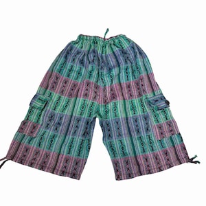 May include: Mid-length pants featuring a vibrant vertical striped pattern in shades of teal, purple, and blue. These pants include an elasticized drawstring waistband, two side cargo pockets with button closures, and adjustable drawstring ties at the leg openings.