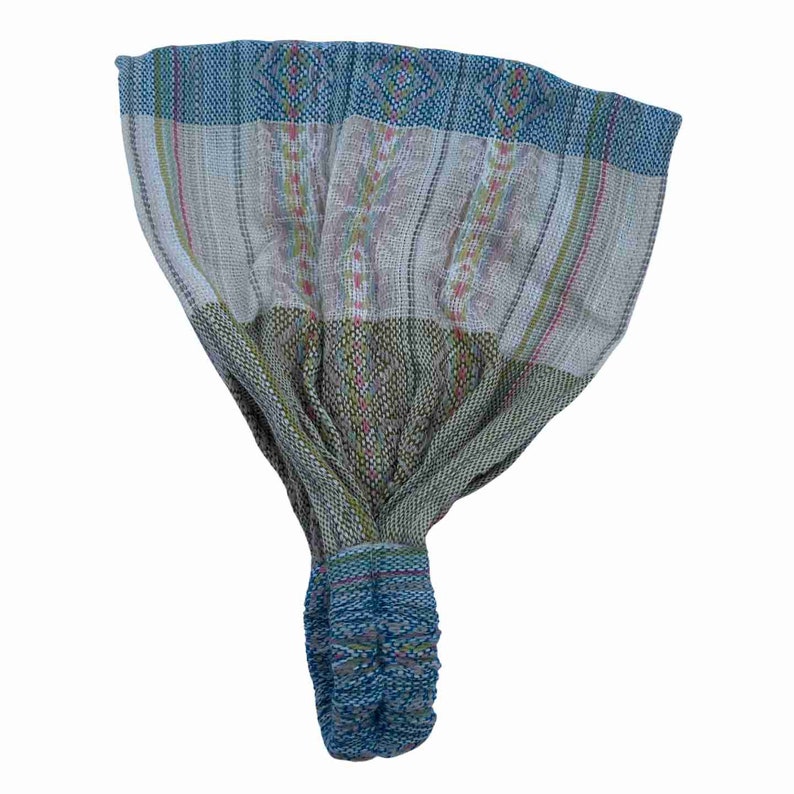 May include: A blue, green, and white patterned headband with a knotted design. The headband is made of woven fabric.