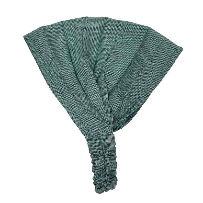 Puede incluir: Una diadema de tela verde con un extremo fruncido. La diadema est&aacute; hecha de una tela suave y texturizada.