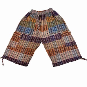 May include: Colorful patterned pants with a drawstring waist and cargo pockets. The pants feature a patchwork design with vertical stripes in shades of orange, purple, blue, and green. The fabric has a textured appearance.