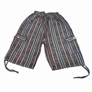 May include: Knee-length cargo shorts featuring a dark brown, black, and light blue vertical striped pattern with intricate geometric motifs. The shorts have an elastic waistband with a drawstring, two side cargo pockets with buttons, and ties.