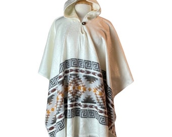May include: White hooded poncho with a geometric pattern in brown, gray, and gold. The poncho has a fringe trim.