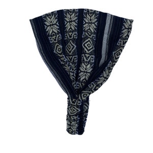 May include: Black and white patterned headband with a geometric design. The headband is made of a soft, stretchy fabric and is perfect for keeping hair out of your face.