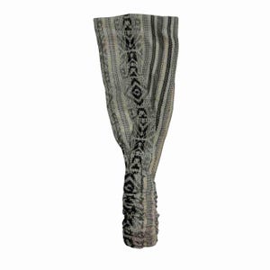 May include: A gray and white headband with a black geometric pattern. The headband is made of a soft, stretchy fabric.