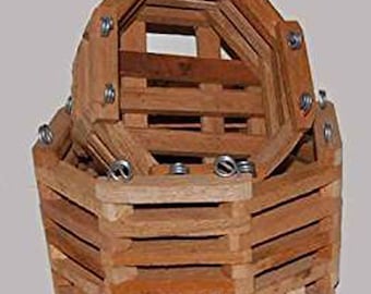 May include: A wooden hanging basket with a multi-sided design. The basket is constructed from light brown wooden slats and held together with metal hardware. The basket is designed to hold plants or other decorative items.