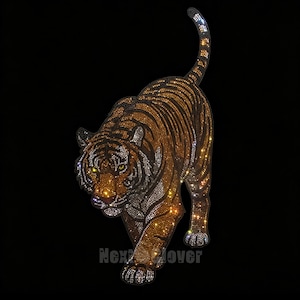 May include: A tiger-shaped patch covered in sparkling orange, black, and white rhinestones, depicting a tiger in a walking pose with its tail raised. The text Next Clover is printed in a subtle grey font at the bottom of the tiger design.
