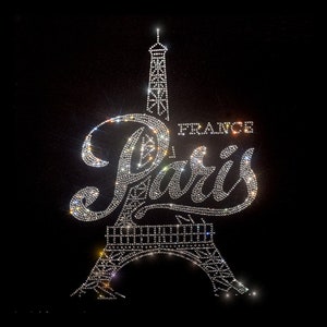 May include: A black background with a sparkling silver Eiffel Tower and the words "Paris, France" in rhinestones.