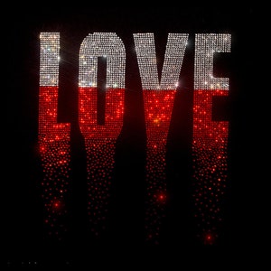May include: The word "LOVE" is spelled out in rhinestones. The top half of each letter is white and the bottom half is red.
