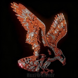 May include: A rhinestone transfer design of a soaring eagle in flight, featuring a gradient of orange, amber, and clear crystals against a black background. The eagle is depicted with wings spread wide and talons extended, with the text NextSlover visible.