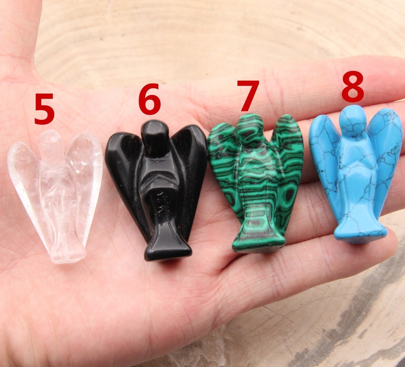 May include: Five carved angel figurines made of different stones. The angels are numbered 5 through 8. The angels are made of clear quartz, black obsidian, green malachite, and blue turquoise.