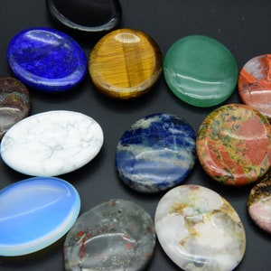 May include: Assortment of oval-shaped polished stones in various colors and patterns, including blue, green, red, brown, white, and black. The stones are smooth and have a natural, polished finish.