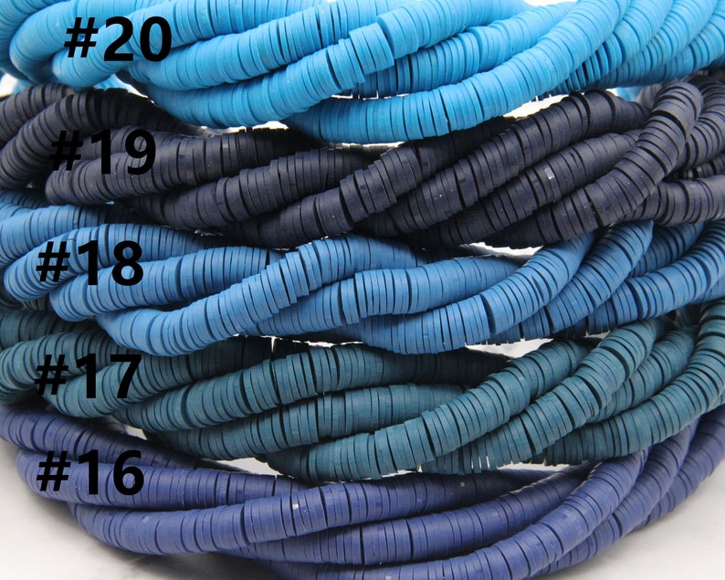 May include: A close-up of a stack of blue and teal colored round plastic beads. The beads are arranged in rows, with each row a slightly different shade of blue. The beads are labeled with numbers 16 through 20.