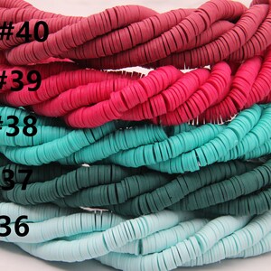 May include: Five strands of colorful polymer clay beads. The beads are flat and round, and they are arranged in a stack. The colors of the beads are red, pink, turquoise, teal, and light blue. The beads are labeled with numbers 40, 39, 38, 37, and 36.