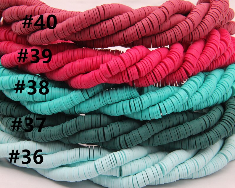 May include: Five strands of colorful polymer clay beads. The beads are flat and round, and they are arranged in a stack. The colors of the beads are red, pink, turquoise, teal, and light blue. The beads are labeled with numbers 40, 39, 38, 37, and 36.