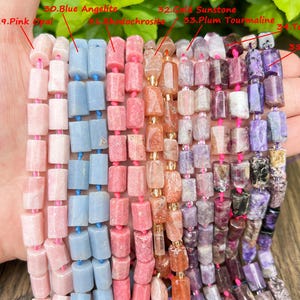 May include: Strands of gemstone beads in various colors, including pink, blue, and purple. The beads are rectangular and strung together with pink or blue string. The gemstones are labeled: Pink Opal, Blue Angelite, Rhodochrosite, Gold Sunstone, Plum Tourmaline, Tourmaline, and Charoite.