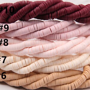 May include: A close-up of ten strands of colorful ceramic beads. The beads are arranged in a graduated color scheme, starting with a deep burgundy red and transitioning to a light beige. Each strand is labeled with a number, from #6 to #10.