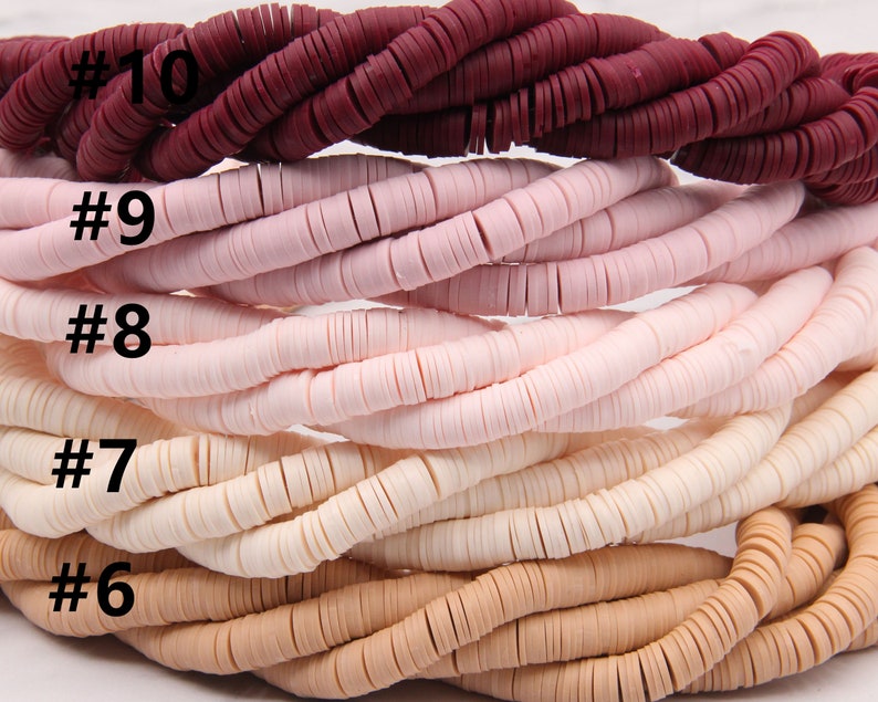 May include: A close-up of ten strands of colorful ceramic beads. The beads are arranged in a graduated color scheme, starting with a deep burgundy red and transitioning to a light beige. Each strand is labeled with a number, from #6 to #10.