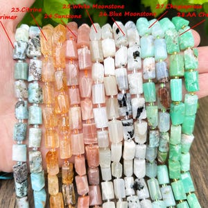 May include: A selection of gemstone beads in various colors, including Larimar, Citrine, Sunstone, White Moonstone, Blue Moonstone, and Chrysoprase. The beads are rectangular and strung together, showcasing a range of natural hues and textures. Ideal for jewelry making.