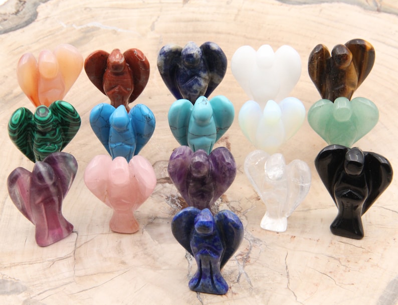May include: A collection of 16 small angel figurines carved from various gemstones, including amethyst, rose quartz, clear quartz, black obsidian, tiger's eye, lapis lazuli, turquoise, malachite, and more.