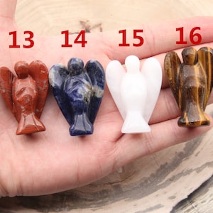 May include: Four angel figurines carved from different types of stone. The angels are red, blue, white, and brown. The numbers 13, 14, 15, and 16 are visible above the angels.