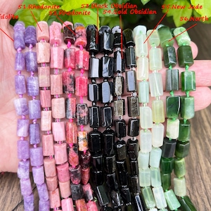 May include: Strands of gemstone beads in various colors, including purple lepidolite, pink rhodonite, black obsidian, and green jade. Each bead is a rectangular shape, strung together with pink thread.