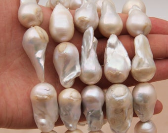 May include: A strand of white baroque pearls with irregular shapes and sizes. The pearls have a smooth, glossy finish and a subtle iridescent sheen.