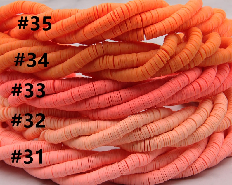 May include: Five strands of orange, pink, and peach colored polymer clay beads. The beads are stacked on top of each other and are all the same size and shape. The beads are labeled with numbers 31 through 35.