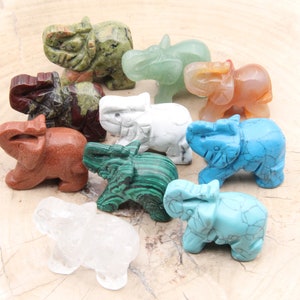 May include: Ten small elephant figurines carved from various types of stone, including green, red, white, brown, and blue.