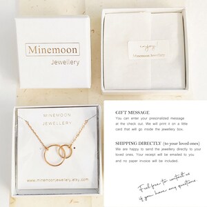 May include: A gold necklace with two interlocking circles, presented in a white box with the text "Minemoon Jewellery". The box is on a beige surface. The text "Feel free to contact us if you have any questions." is written in black ink on a white background.