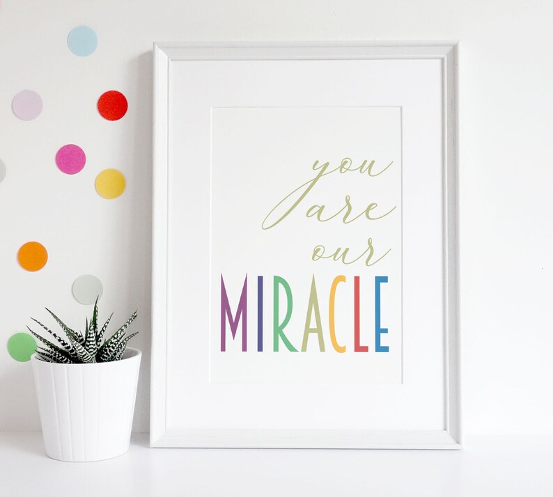May include: White framed print with the text "you are our MIRACLE" in rainbow colors.