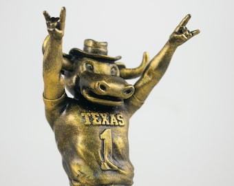 Samlarfigur i gyllene form av Bevo Hook'em, University of Texas Longhorns maskot