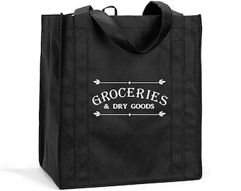 May include: Black reusable tote bag with white text that reads "Groceries & Dry Goods" in a vintage font.