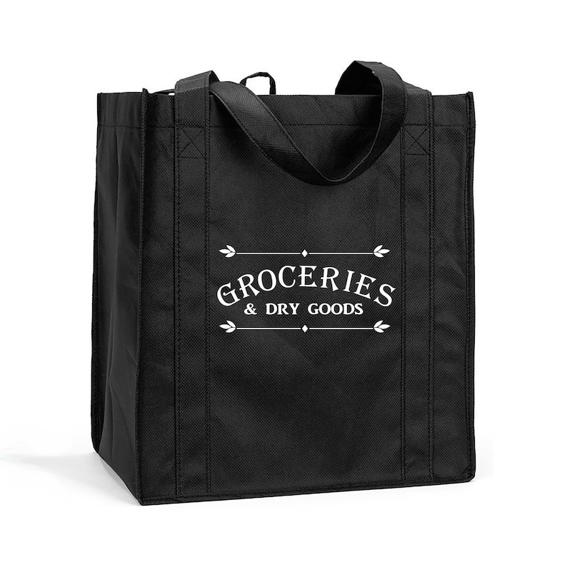 May include: Black reusable tote bag with white text that reads "Groceries & Dry Goods" in a vintage font.