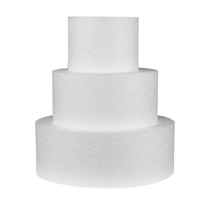 May include: A three-tiered, white foam cake form. The base is the largest, followed by a medium layer, and a small top tier. The foam has a textured surface, and the form is designed for cake decorating.