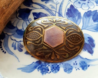 Old brooch made of brass and enamel