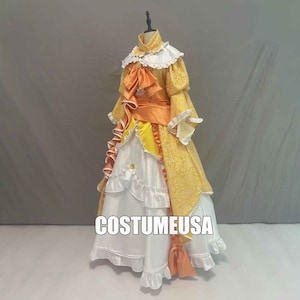 May include: A yellow and white dress with a ruffled skirt and a large orange bow. The dress has a lace collar and long sleeves. The dress is on a mannequin and the text "CostumeUSA" is visible on the bottom of the dress.