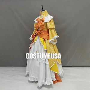 May include: A yellow and white dress with orange accents and lace detailing. The dress has a large bow at the neckline and a ruffled skirt.