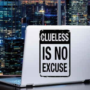 May include: A laptop computer with a black and white sticker that says "Clueless is no excuse".
