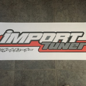 May include: White banner with the words "IMPORT TUNER" in gray and red lettering. The text "インポートチューナー" is in black below the logo.