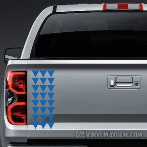 May include: A silver pickup truck with a blue triangle pattern decal on the tailgate. The decal is a traditional Hawaiian design.