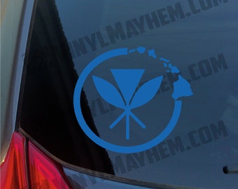 May include: A blue vinyl decal applied to a vehicle window, featuring a circular frame that encloses a stylized Hawaiian floral emblem on the left and a silhouette map of the Hawaiian Islands on the right, with the text VINYLMAYHEM.COM visible.