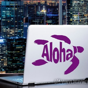 May include: Purple vinyl sticker of a sea turtle with the word "Aloha" inside the turtle's shell. The sticker is on a laptop computer.