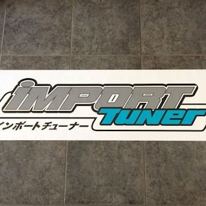 May include: White banner with the text "IMPORT TUNER" in blue and gray lettering. The text "インポートチューナー" is also on the banner in Japanese.