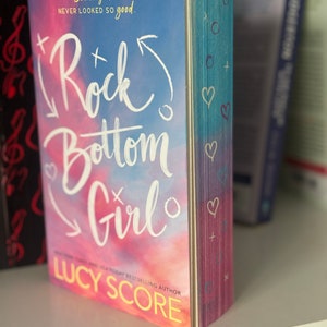 Rock Bottom Girl by Lucy Score Sprayed Edges