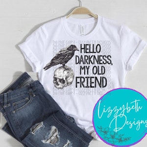 May include: White t-shirt with a black and white illustration of a raven perched on a skull. The text "Hello Darkness, My Old Friend" is printed on the shirt.