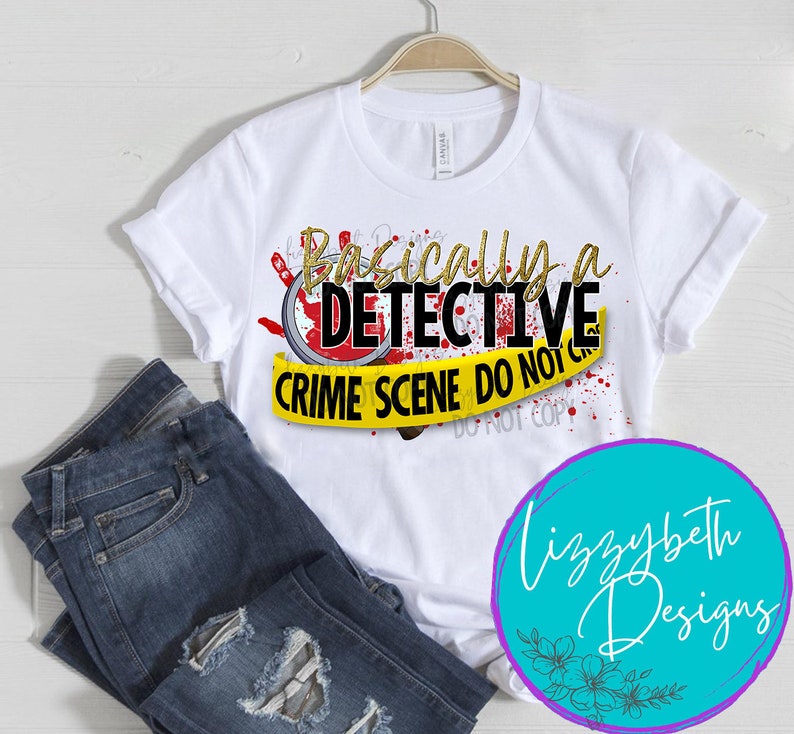 May include: White t-shirt with a gold glitter graphic that says "Basically a Detective Crime Scene Do Not Cross" with a red magnifying glass and blood splatter. The graphic is on a yellow caution tape background.